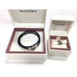 A Pandora bracelet and a bead both with boxes. Pos