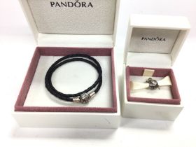 A Pandora bracelet and a bead both with boxes. Pos