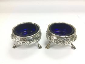 A pair of Georgian silver salts with blue glass li