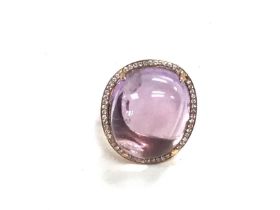 An 18ct gold ring set with a large amethyst surrou