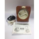 An automatic watch winder with wood effect finish, instructions and power supply. Shipping