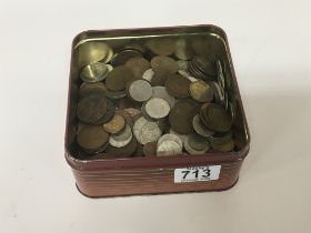 A tin containing mixed used circulated world coina