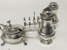 A silver toast rack silver mustard pot and condiments. All with Birmingham hallmarks.