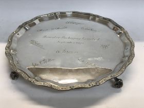 A silver card tray with shaped edge and scrolled feet with engraved signatures Edinburgh