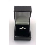 A 9ct gold solitare diamond 0.20ct ring with twist design shank, Size M. (A)
