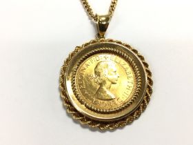 A 1963 full gold sovereign in mount with chain (18