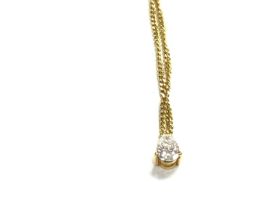An 18ct gold pear shaped diamond pendant with chai