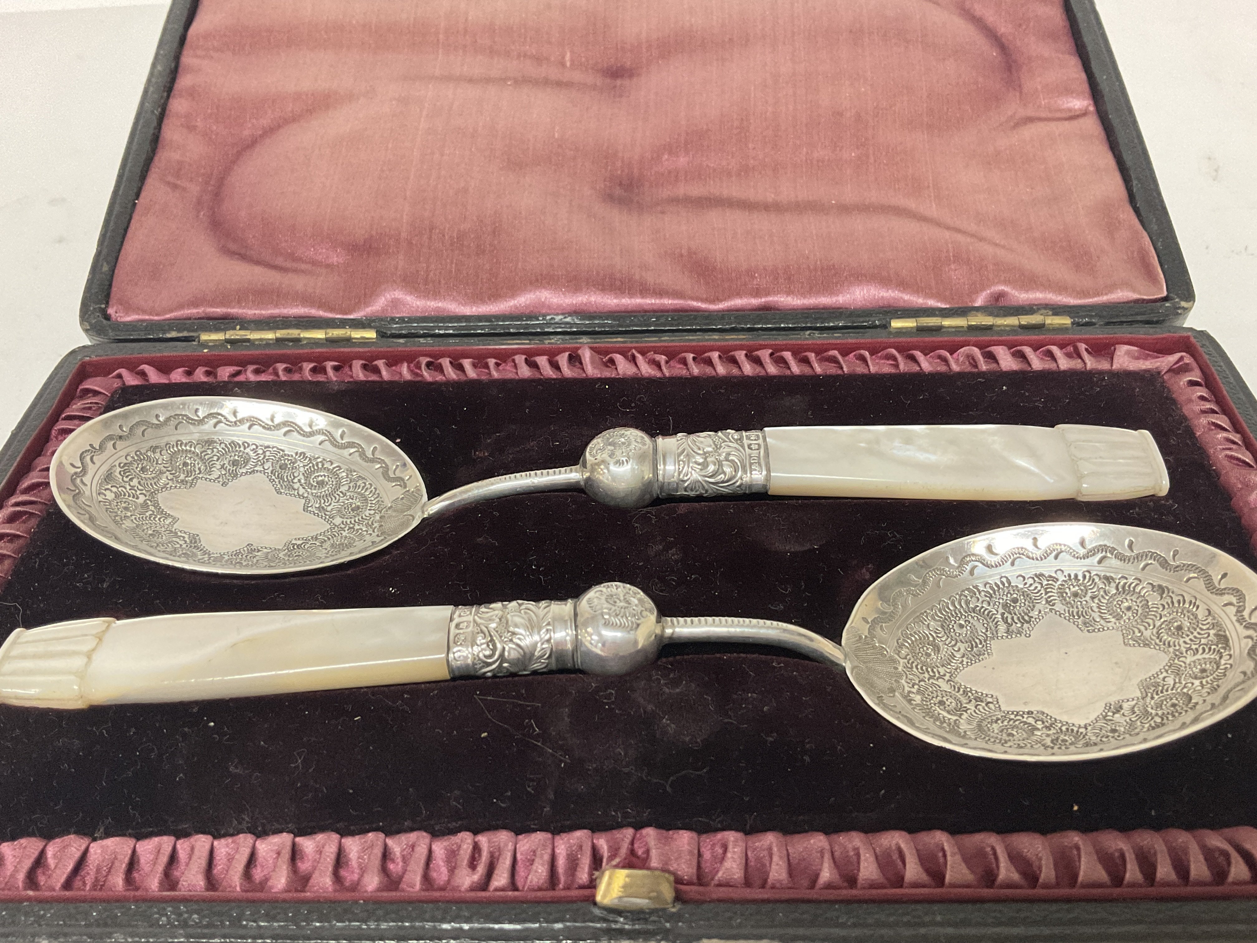 A pair of boxed silver hallmarked spoons , postage
