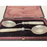 A pair of boxed silver hallmarked spoons , postage