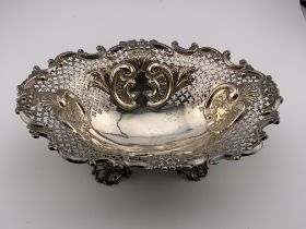 A hallmarked silver embossed and pierced footed Bo