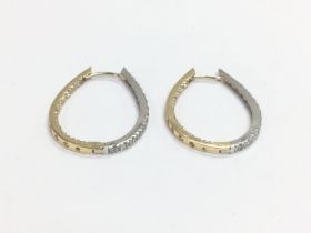 A pair of 14k yellow and white gold stone set earr