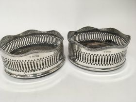 A pair of silver wine coasters with shaped and pie
