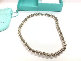 A silver Tiffany and co beaded necklace. Complete