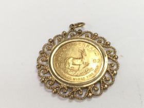 A 1/10 oz 1982 gold krugerrand in 9ct mount. Total