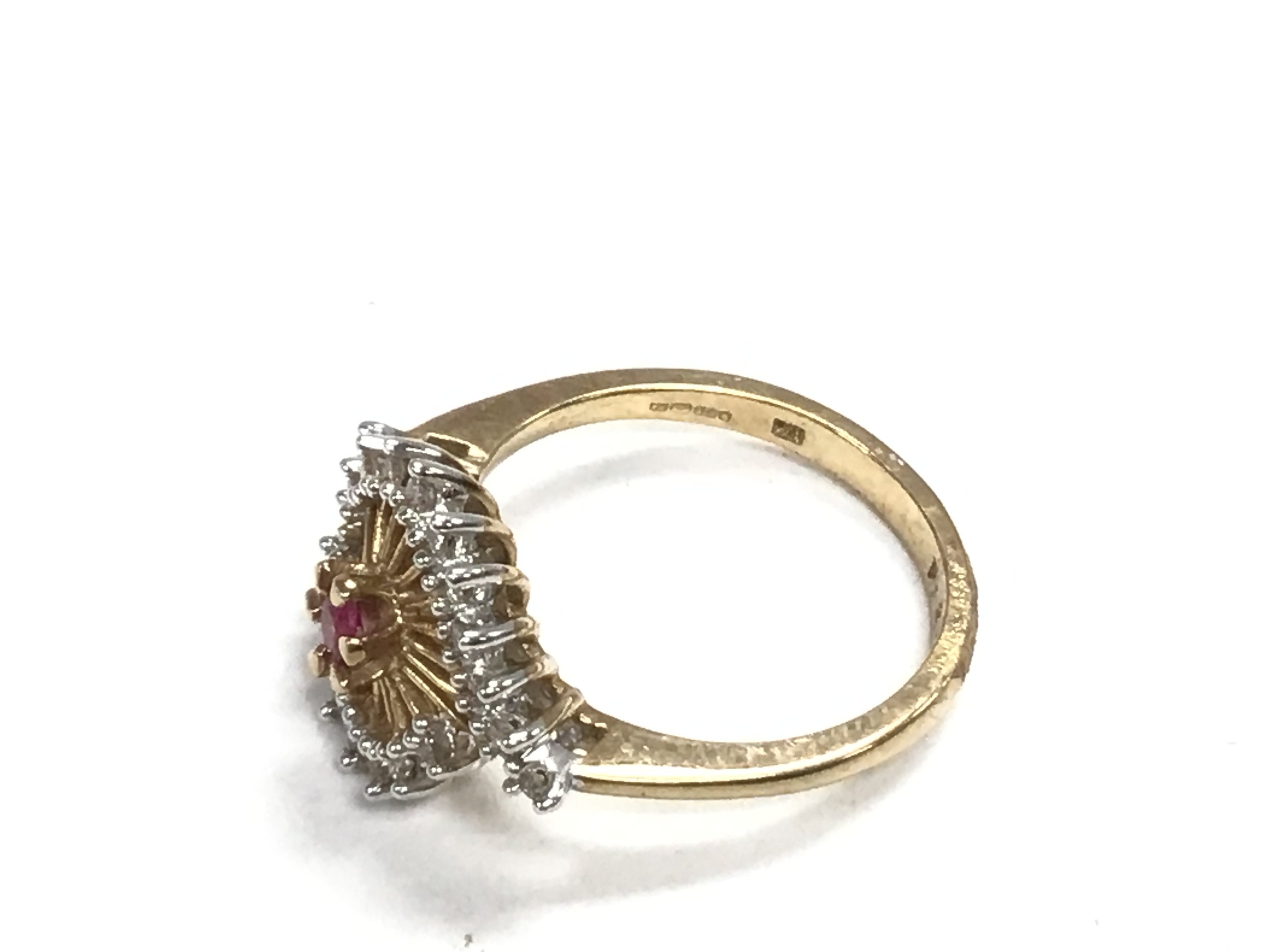 A 9ct gold ruby and diamond set spiral ring. 3.4g - Image 2 of 2