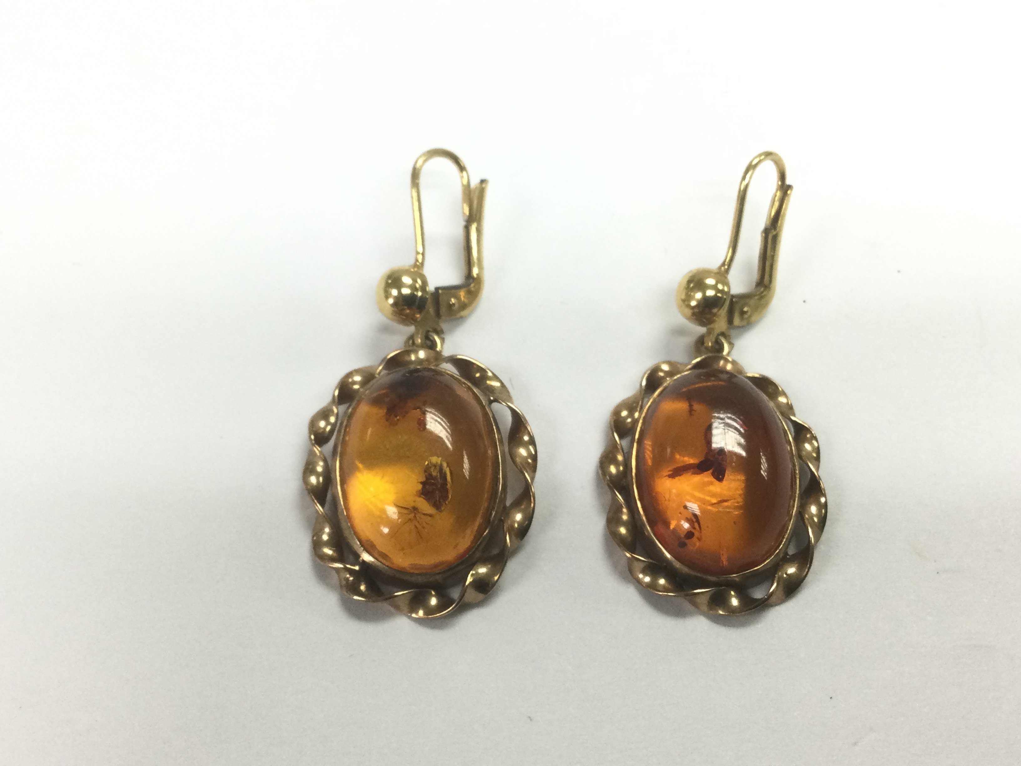 A pair of 9ct gold cabochon amber earrings, approx
