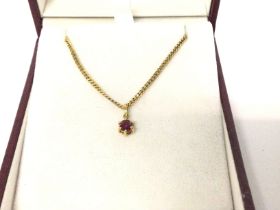 A 9ct gold chain with a ruby pendant. 4g total. Postage B