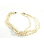 Simulated pearls with a 9ct gold clasp. One of the