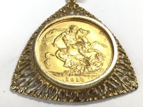 A 1913 full gold sovereign in a 9ct mount and chai