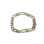 A 9ct solid link gold bracelet set with stones. 17