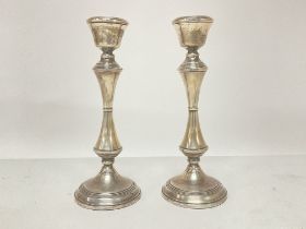 A pair of silver hallmarked candlesticks ,20cm tal