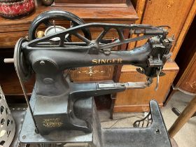 A Treadle operated Shoemakers 'Singer sewing machine' made from cast iron painted black with gold