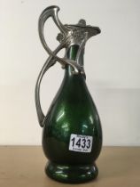 An Art Nouveau style ewer with pewter mounts surmo