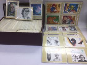 A collection of first day covers, loose and in bin