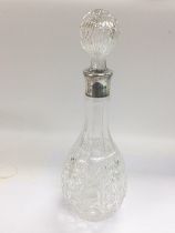 A glass decanter with a silver plated rim, approx total height 34cm. Shipping category D.