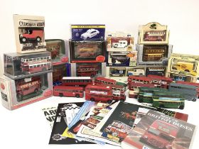 A collection of various model die cast buses and c