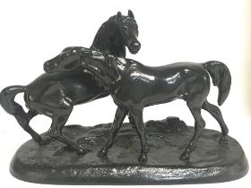 A Soviet Russian black metal statue of two horses, approximately 24cm wide & 16cm tall. Postage