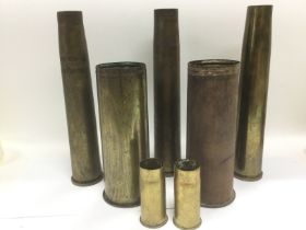 Seven brass shell cases. Shipping category D.