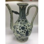 A blue and white ewer decorated in the Oriental taste, approx height 38cm. Shipping category D.