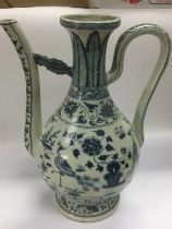 A blue and white ewer decorated in the Oriental taste, approx height 38cm. Shipping category D.