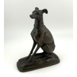 A small cast bronze figure of a. Seated Whippet impressed signature E.Salmon. (B)