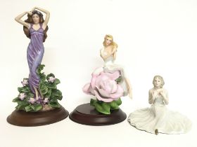 A collection of porcelain figures including a Roya