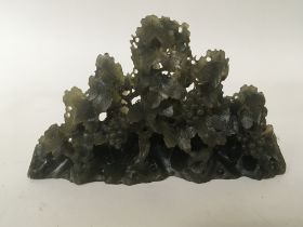 A composition jade type sculpture in the form of g