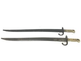 A pair of French sword bayonets with brass handles