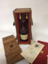 An empty bottle of Martell silver jubilee Cognac broken bottle in a wooden case. With certificate