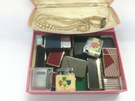 A small box of lighters, necklace etc. Shipping category D.