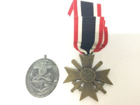 War Merit Cross With Swords Kvk & a WW2 Westwall medal. Postage category A