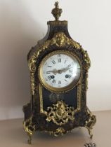 A French Boulle work clock with a white enamel dial the movement striking on a bell. Height 38cm