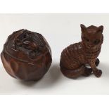 Two carved Netsukes in the form of a cat and an animal inside a cabbage