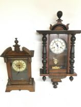 A Continental wall clock (needs restoring) and one other walnut clock, with keys postage category D.