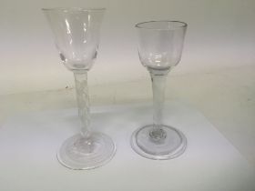 Two 18th Century wine glasses one with an air twist multi cane stem slight chip to base edge (2)
