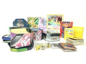 A collection of modern Pokemon cards including tin