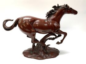 A cast bronze lacquered model of a galloping horse. 27cm x 36cm.