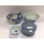 Four blue and white china items comprising three bowls and a circular pot and cover, largest bowl