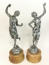 A pair of chrome Art Deco figures,mounted on marbles bases. Approximately 34cm tall. Postage