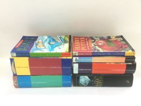 Seven Harry Potter books including first editions.